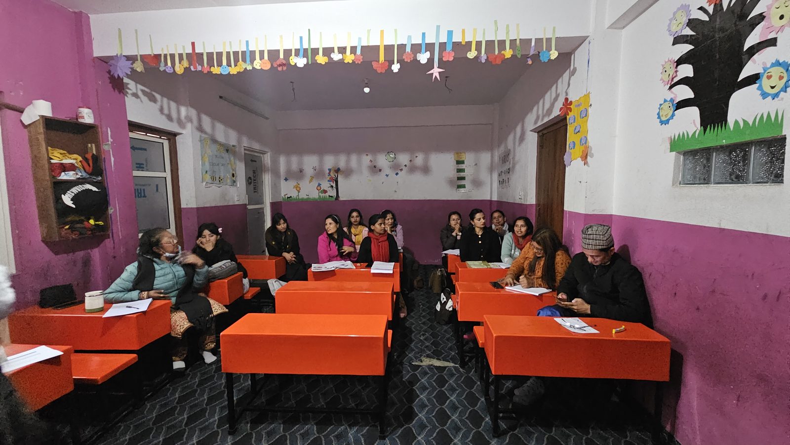 Teachers at orange desks